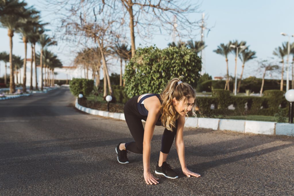 Excited motivated amazing woman preparing to run on street in sunny morning. Workout, training, expressing positivity, true emotions, healthy lifestyle, hardworking.