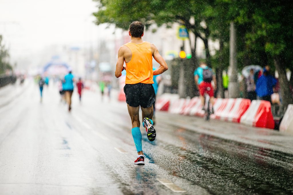 back runner athlete run in rain