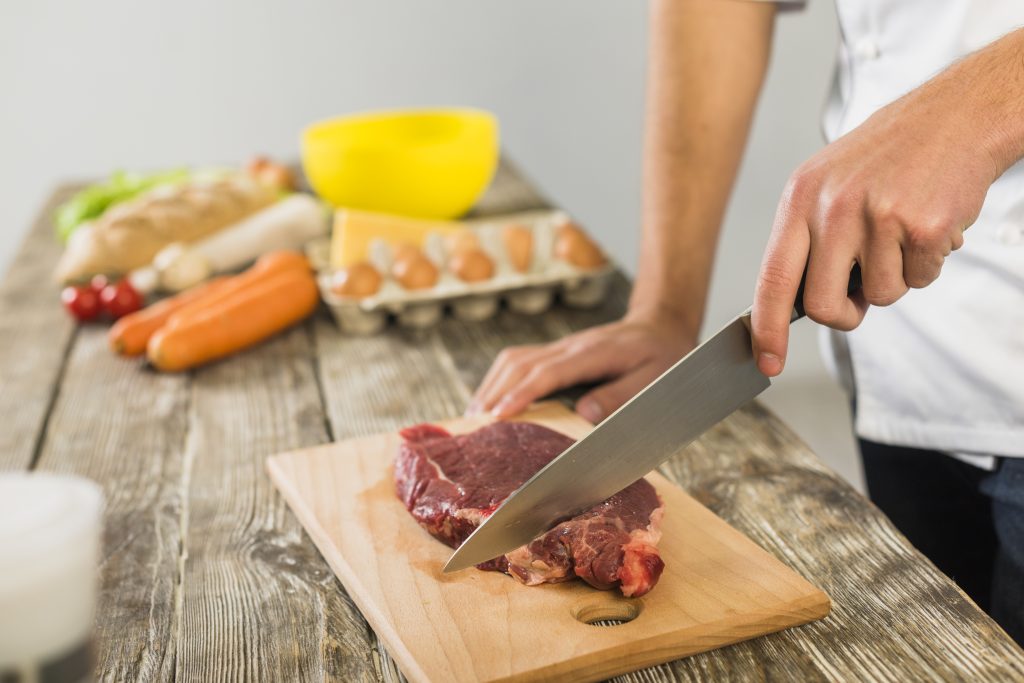 chef-kitchen-cutting-meat