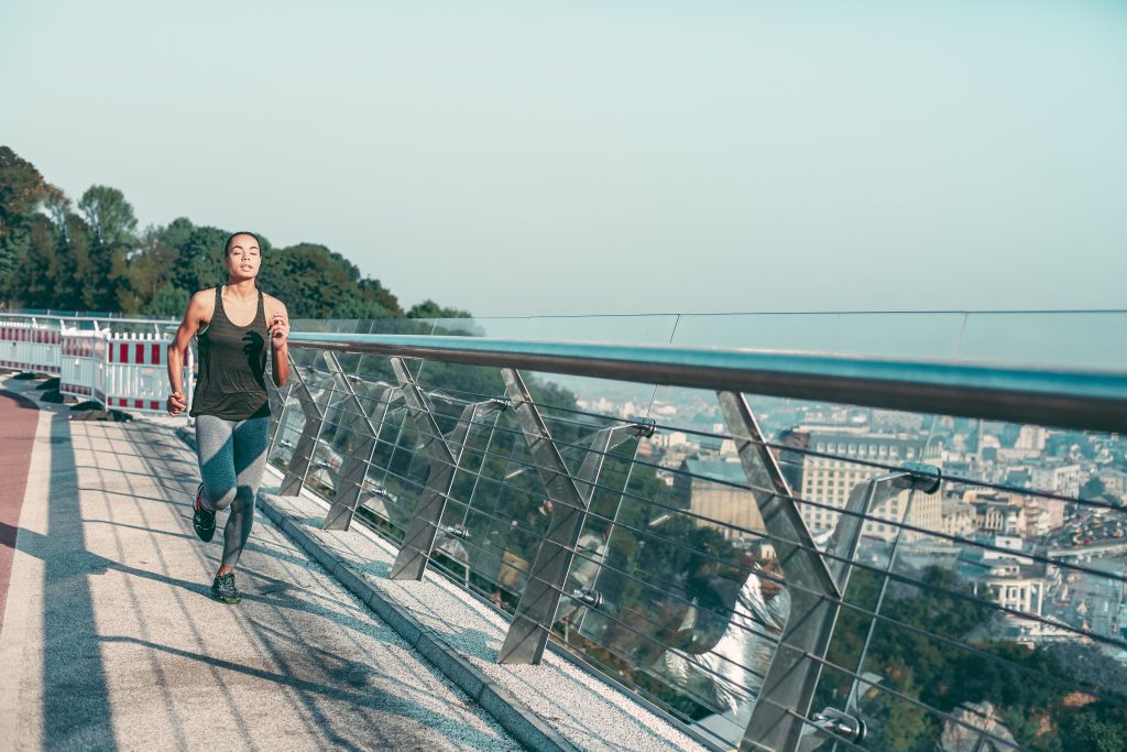 View of the city and woman running stock photo