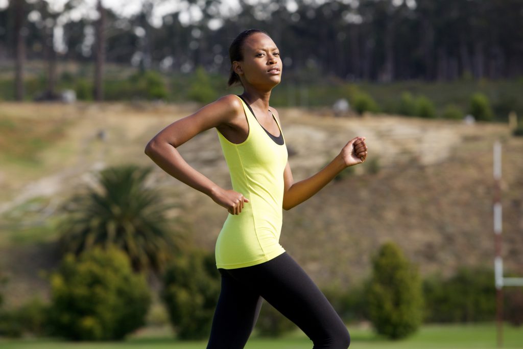 Fit african woman running outdoors