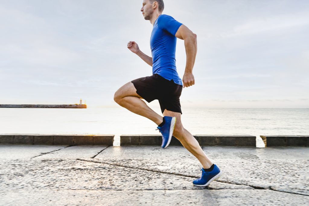 man runner running in morning light of dawn