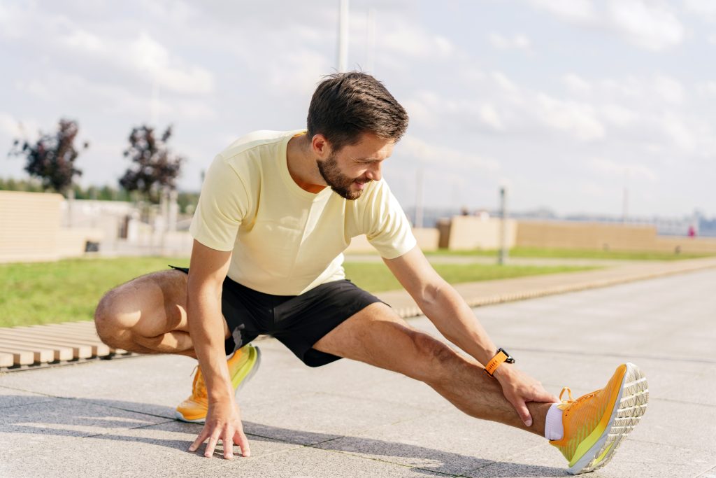 functional-training-stretching-challenge-man-smiles-cardio-workout-sporty-man-sportswear