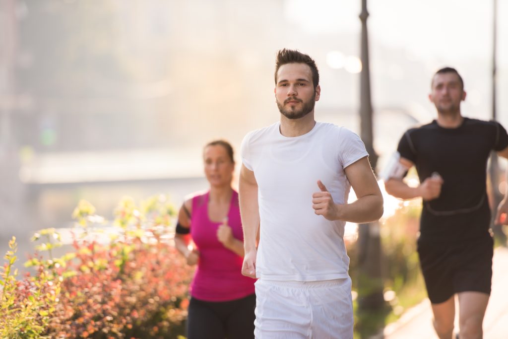 group of young people jogging in the city