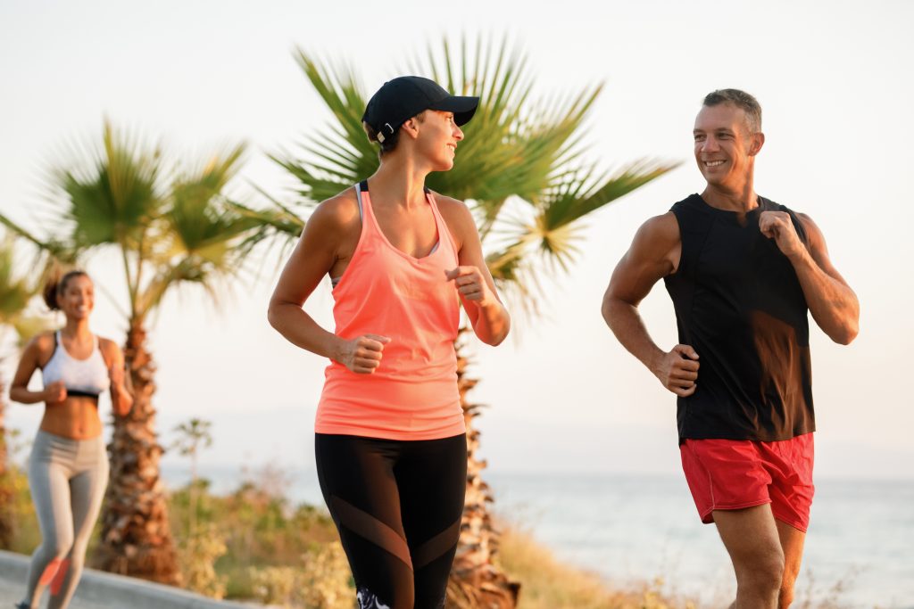 Dedicated athletes communicating while jogging in nature.