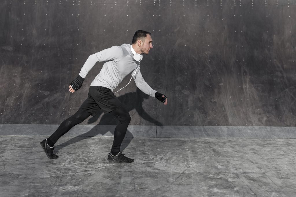 lateral-view-handsome-man-running-outside