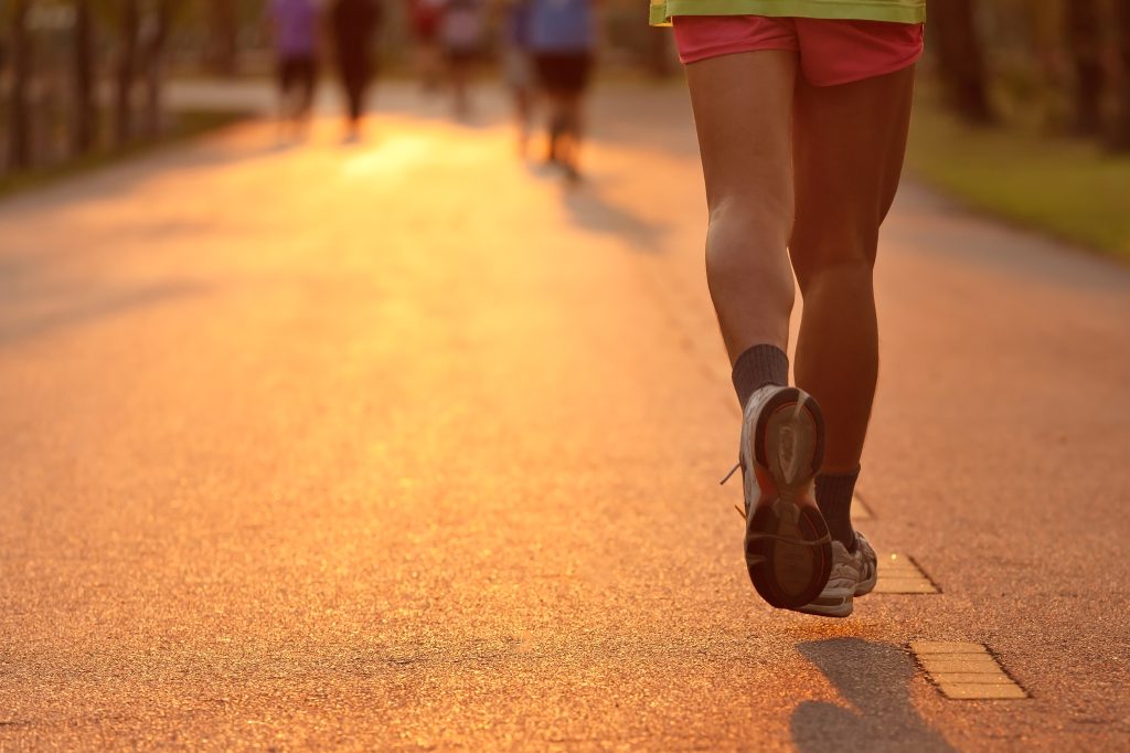 Feet of runner in evening light