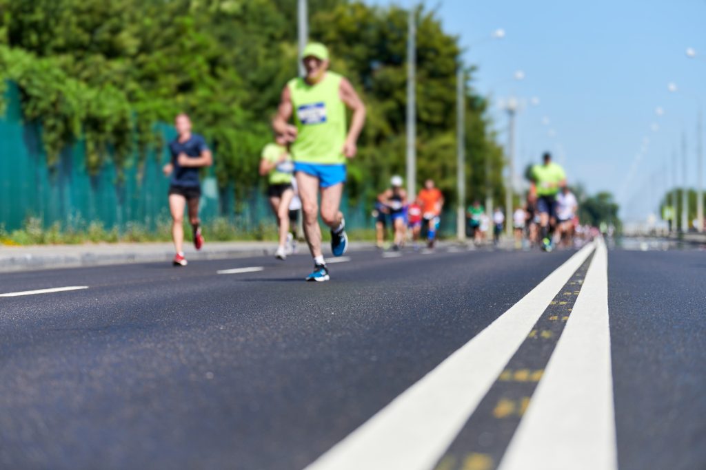 Runners on city road.