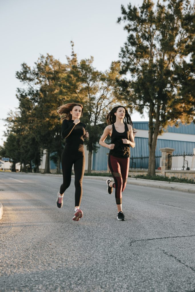 sportswomen-running-street-sunlight